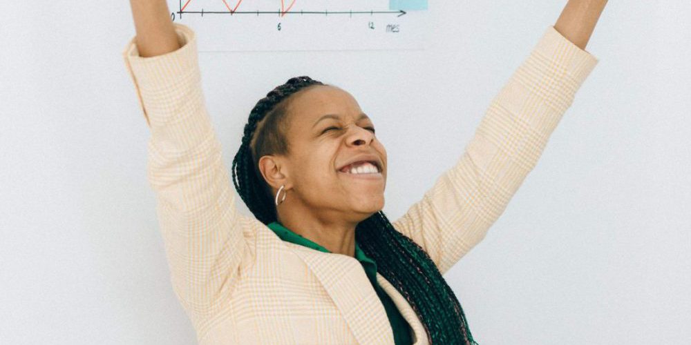 woman with eyes closed and arms in the air